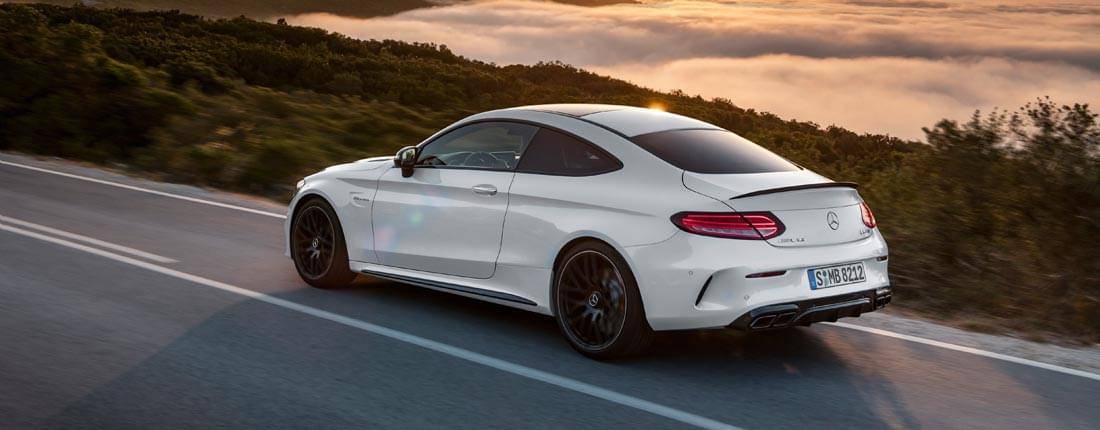 Mercedes-Benz coupe in motion, front-side view.